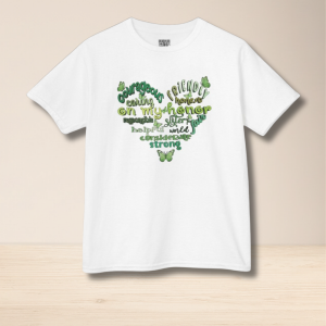 T‑shirt with green and yellow heart‑shaped word cloud featuring positive Scout values and butterflies