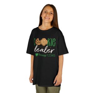 T‑shirt with green “Cookie Dealer Troop” design featuring smiling cookie characters