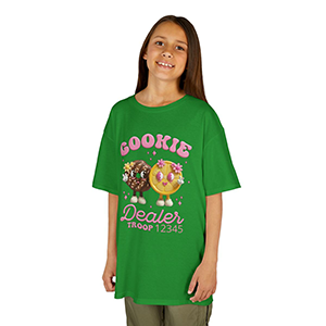 Child wearing a green “Cookie Dealer Troop” T‑shirt with cute cookie characters